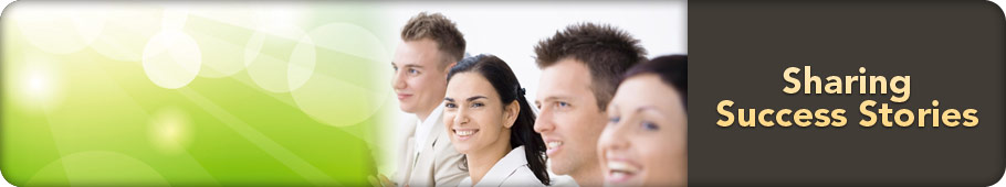 Four colleagues standing together, smiling and looking ahead
